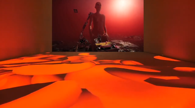installation shot of a projected video with floating red blood cells projected over the entire floor